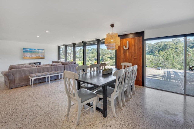 dining space featuring a wealth of natural light, speckled floor, and recessed lighting