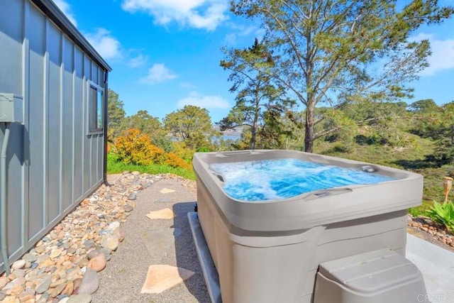 view of pool with a hot tub