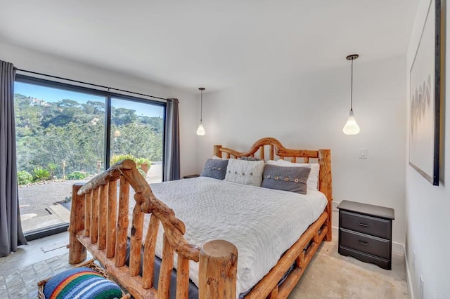 bedroom featuring baseboards and access to exterior