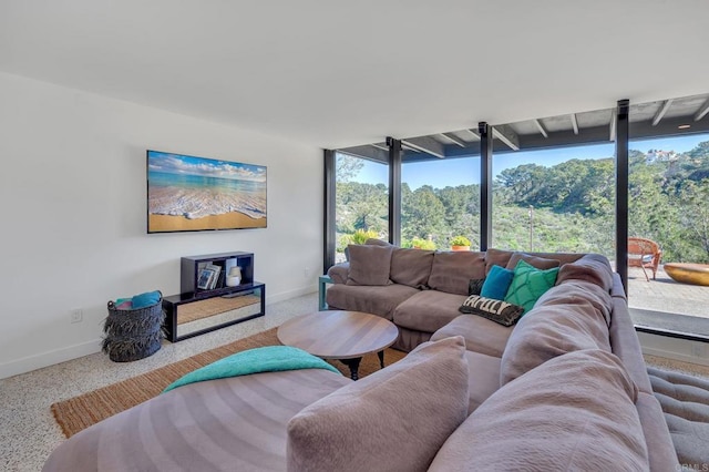 living area with speckled floor and baseboards