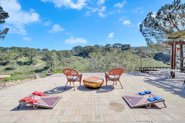 view of patio / terrace featuring a forest view