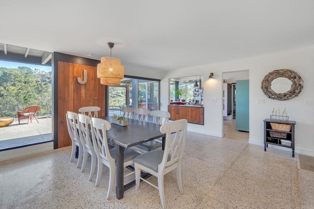 dining room with baseboards and light speckled floor