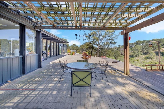 view of patio with outdoor dining area, a pergola, and a grill