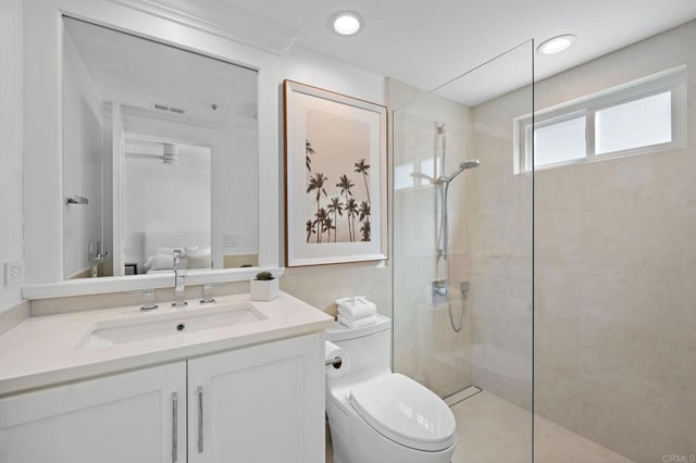 bathroom featuring recessed lighting, toilet, vanity, and a walk in shower