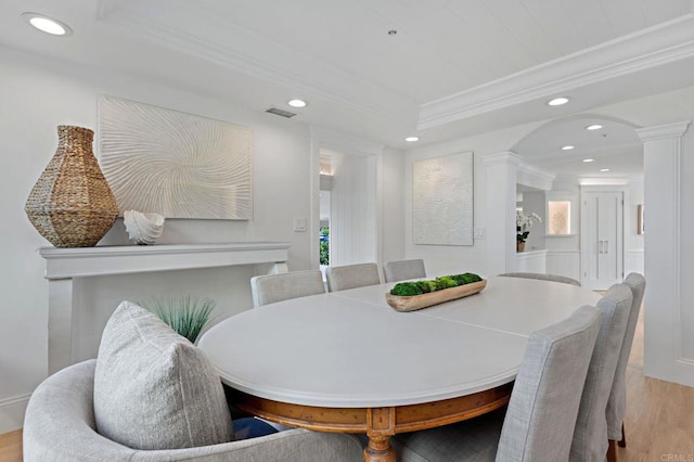 dining space featuring recessed lighting, visible vents, wood finished floors, and decorative columns