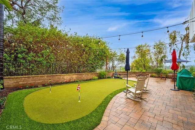 view of property's community with a patio area and a fenced backyard