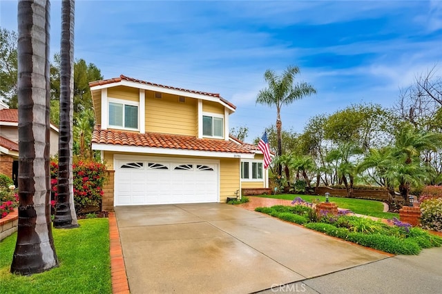 view of front of home with a tile roof, an attached garage, a front lawn, and driveway