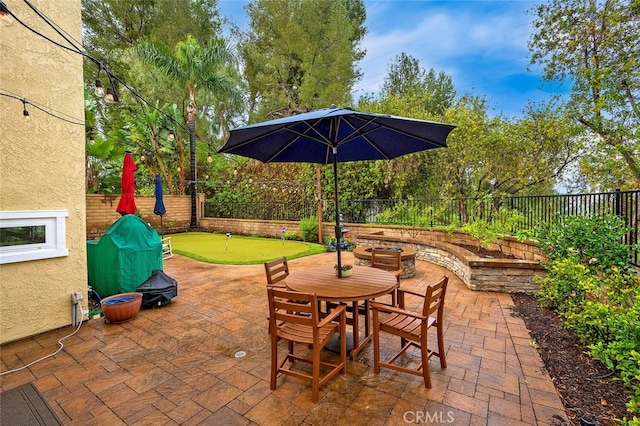 view of patio with outdoor dining space and a fenced backyard