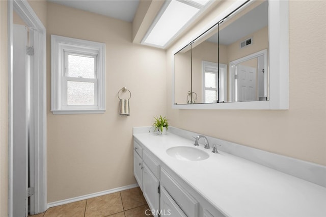 bathroom with vanity, tile patterned floors, baseboards, and visible vents