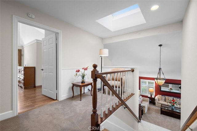 stairs with recessed lighting, carpet, and a skylight