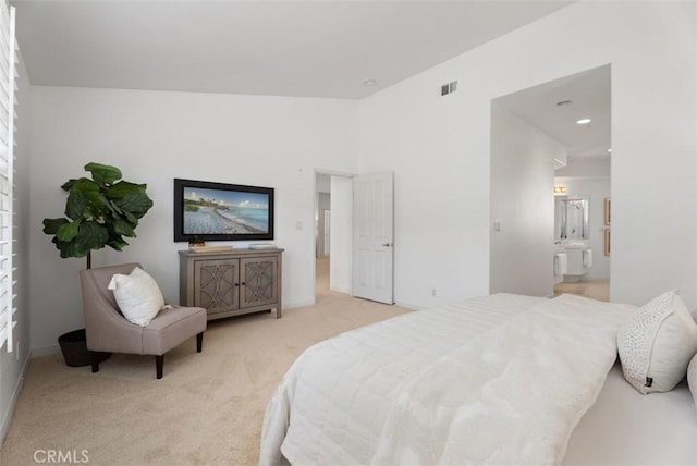 bedroom featuring visible vents, light colored carpet, ensuite bathroom, and lofted ceiling