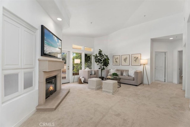 living room with a glass covered fireplace, carpet flooring, recessed lighting, and baseboards