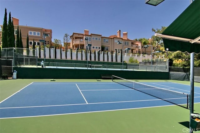 view of sport court featuring a residential view and fence