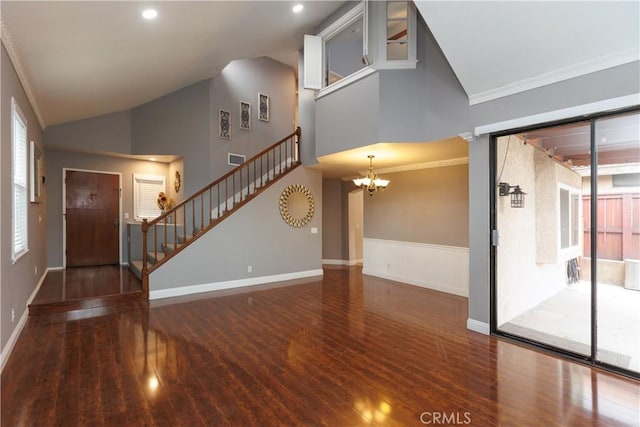 foyer with an inviting chandelier, stairway, wood finished floors, and baseboards