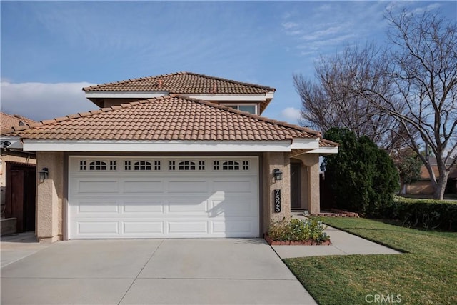 view of front of house with a garage, concrete driveway, a front yard, and stucco siding