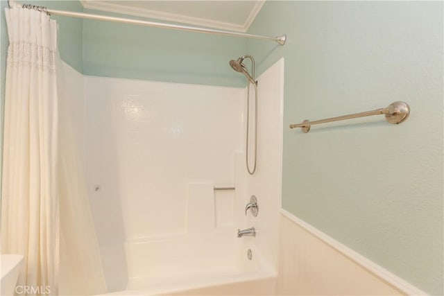 bathroom featuring shower / tub combo with curtain, ornamental molding, and toilet