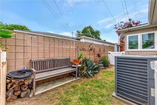 view of yard featuring central AC unit and fence