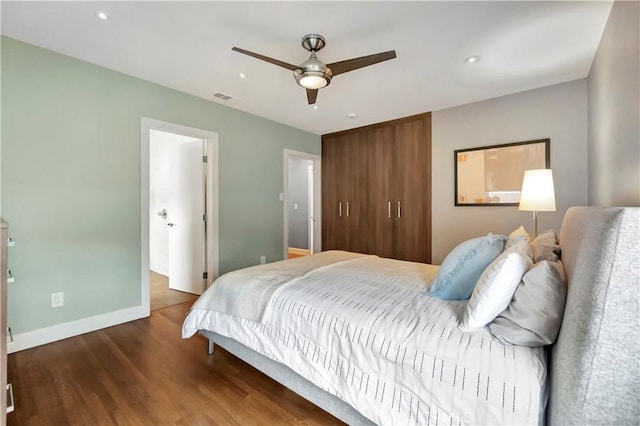 bedroom with visible vents, ceiling fan, baseboards, recessed lighting, and wood finished floors