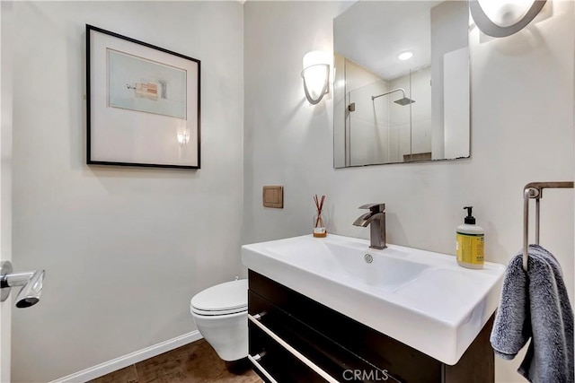 full bathroom with baseboards, toilet, a stall shower, and vanity