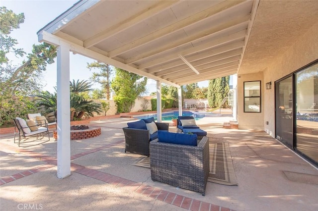 view of patio featuring a fenced in pool, a fire pit, and a fenced backyard