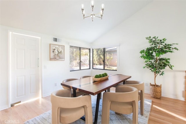 dining area featuring an inviting chandelier, light wood-style floors, visible vents, and baseboards