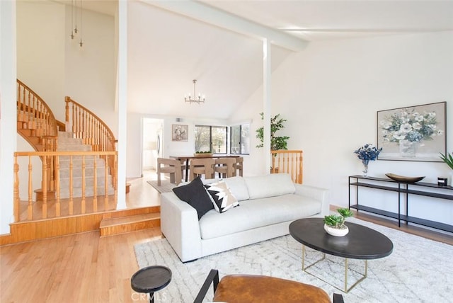 living room featuring beamed ceiling, a notable chandelier, high vaulted ceiling, wood finished floors, and stairway