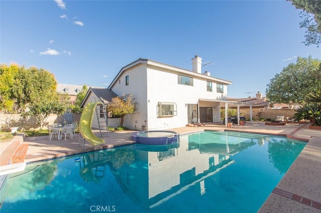 view of pool with a patio, fence, a pergola, and a water slide