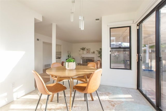 dining area featuring visible vents and a fireplace