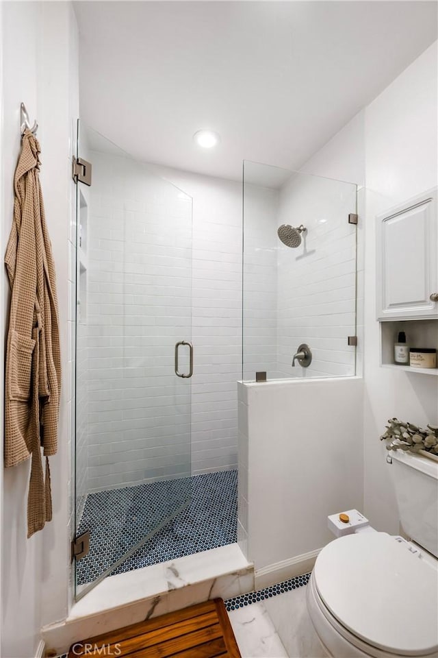 full bath featuring toilet and a shower stall