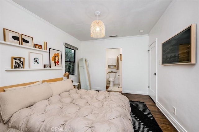 bedroom featuring visible vents, baseboards, ornamental molding, wood finished floors, and arched walkways