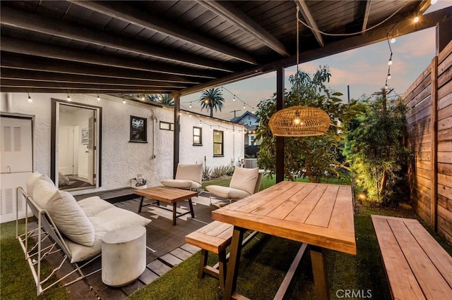 view of patio featuring outdoor dining area and fence