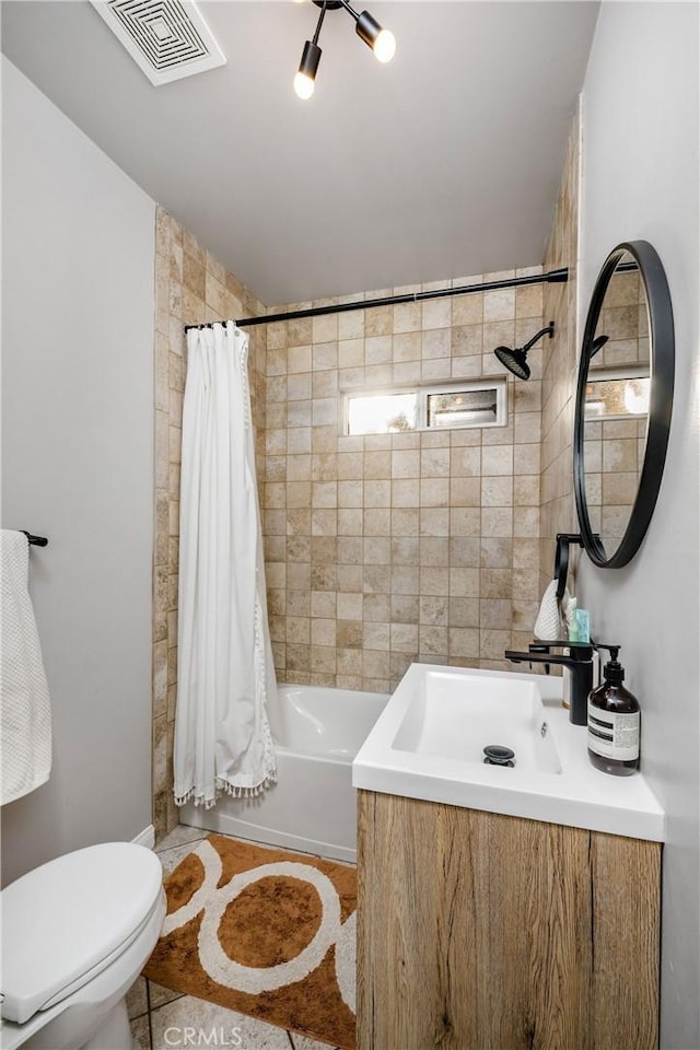 full bath with visible vents, toilet, vanity, and shower / bath combo