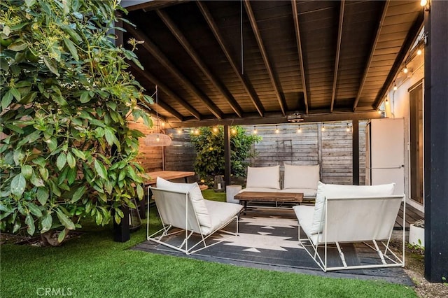 view of patio with an outdoor living space and fence