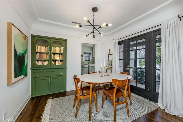 dining space featuring visible vents, baseboards, dark wood finished floors, french doors, and an inviting chandelier