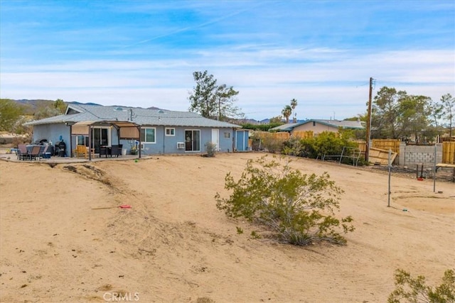 back of house featuring a patio area and fence