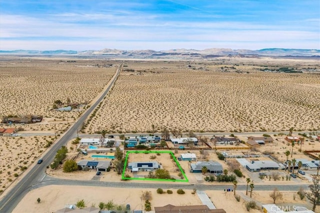 drone / aerial view with a mountain view and view of desert