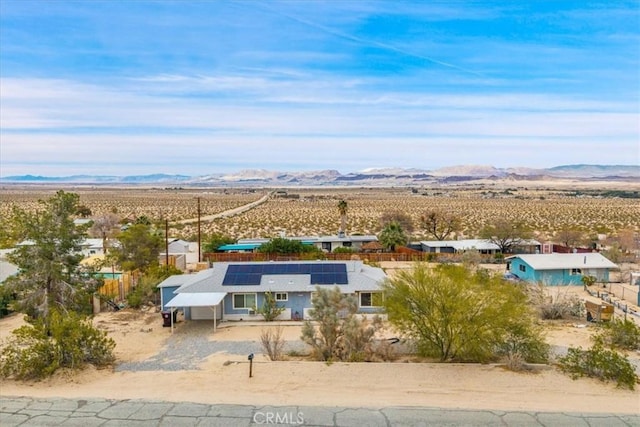 drone / aerial view featuring a desert view and a mountain view