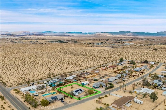 bird's eye view with a mountain view and view of desert