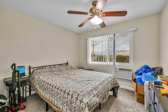 carpeted bedroom featuring baseboards, an AC wall unit, and ceiling fan