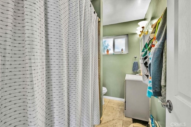 full bath with tile patterned floors, toilet, vanity, and baseboards