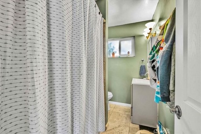bathroom with vanity, a shower with curtain, baseboards, toilet, and tile patterned flooring