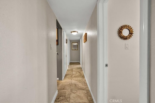 hallway featuring baseboards