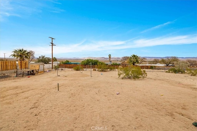 view of yard with a rural view and fence