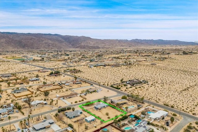 drone / aerial view with a mountain view and view of desert