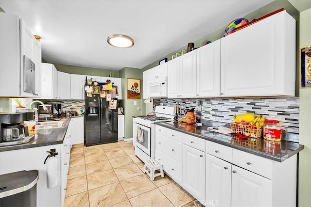 kitchen with a sink, dark countertops, tasteful backsplash, white cabinetry, and white appliances