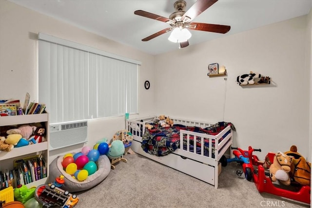 carpeted bedroom with a wall mounted air conditioner and a ceiling fan