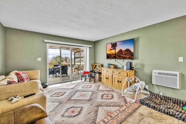 living area featuring tile patterned floors, a wall mounted AC, and baseboards