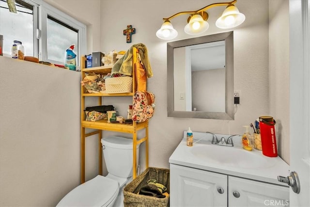 bathroom featuring toilet and vanity