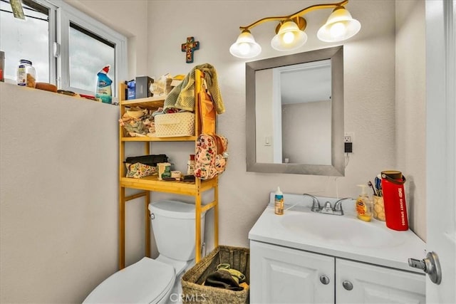 bathroom featuring toilet and vanity