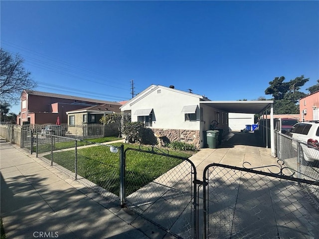 view of front facade with a gate, stone siding, a fenced front yard, and stucco siding